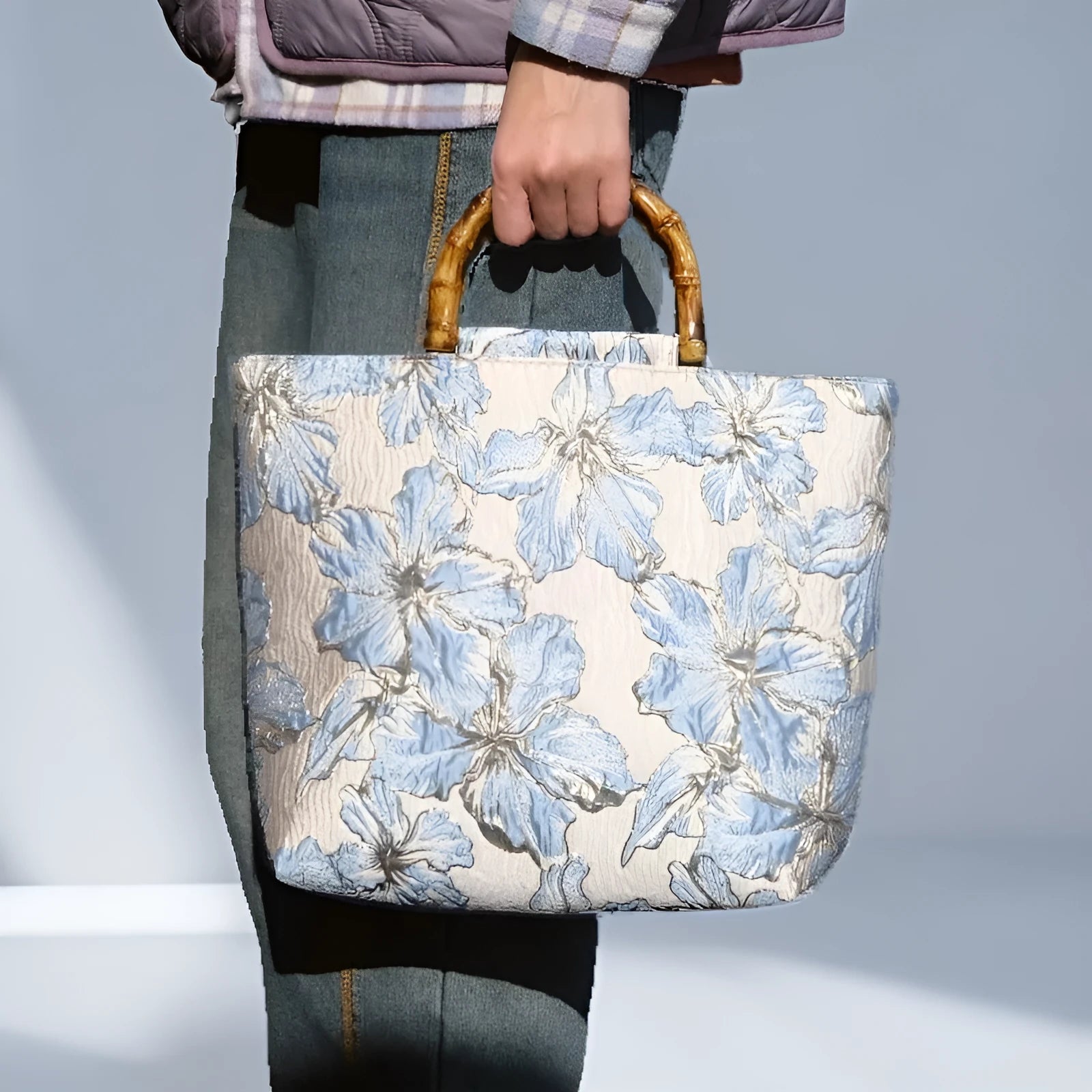 Light blue canvas shoulder bag with bronzing flower pattern, showing square shape and double shoulder straps