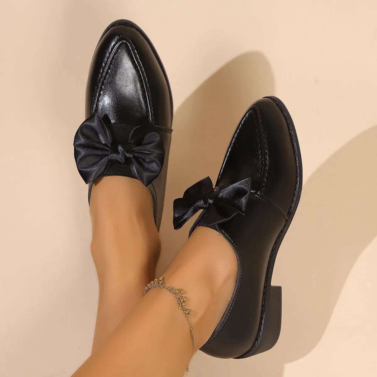 Women's British-style loafers with a bow detail on a PU upper and rubber sole.
