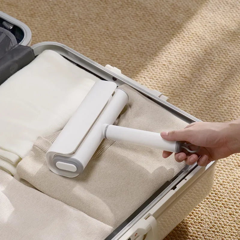 Refillable lint remover roller with tearable paper for pet hair removal on household surfaces