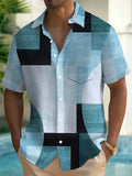 Man wearing a loose-fit short sleeve cardigan shirt with a blue and white geometric 3D print pattern.