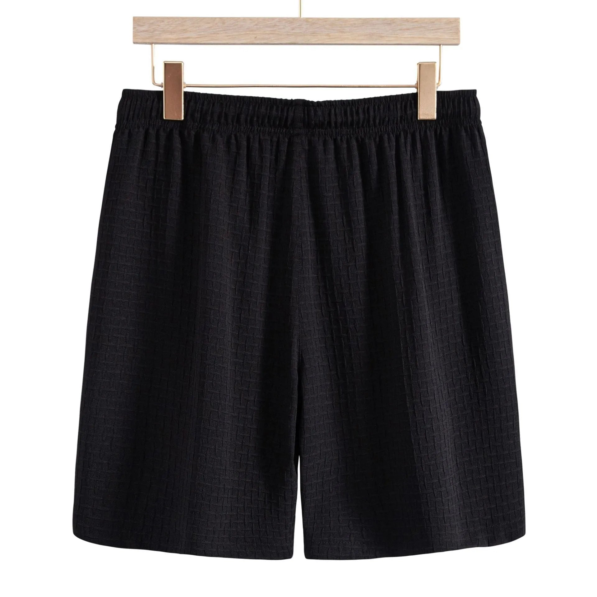 Men's white cotton blend beach shorts suit with short sleeve shirt on a hanger.