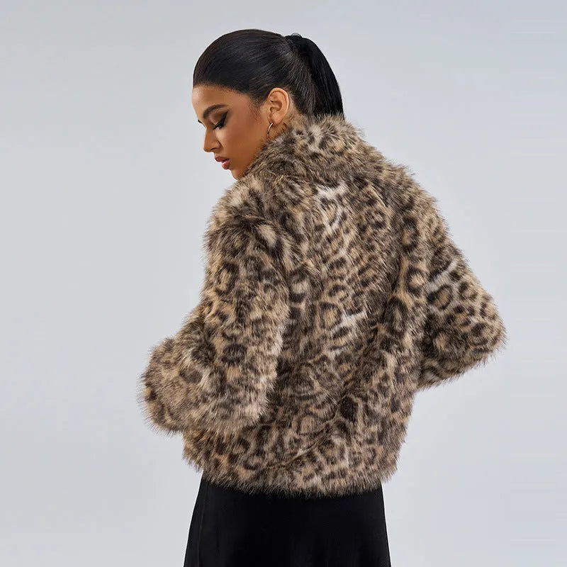 Women's leopard print coat with a buckle lapel fastening on a hanger.