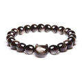 Handmade natural stone bead bracelet with silver cat pendant on neutral background