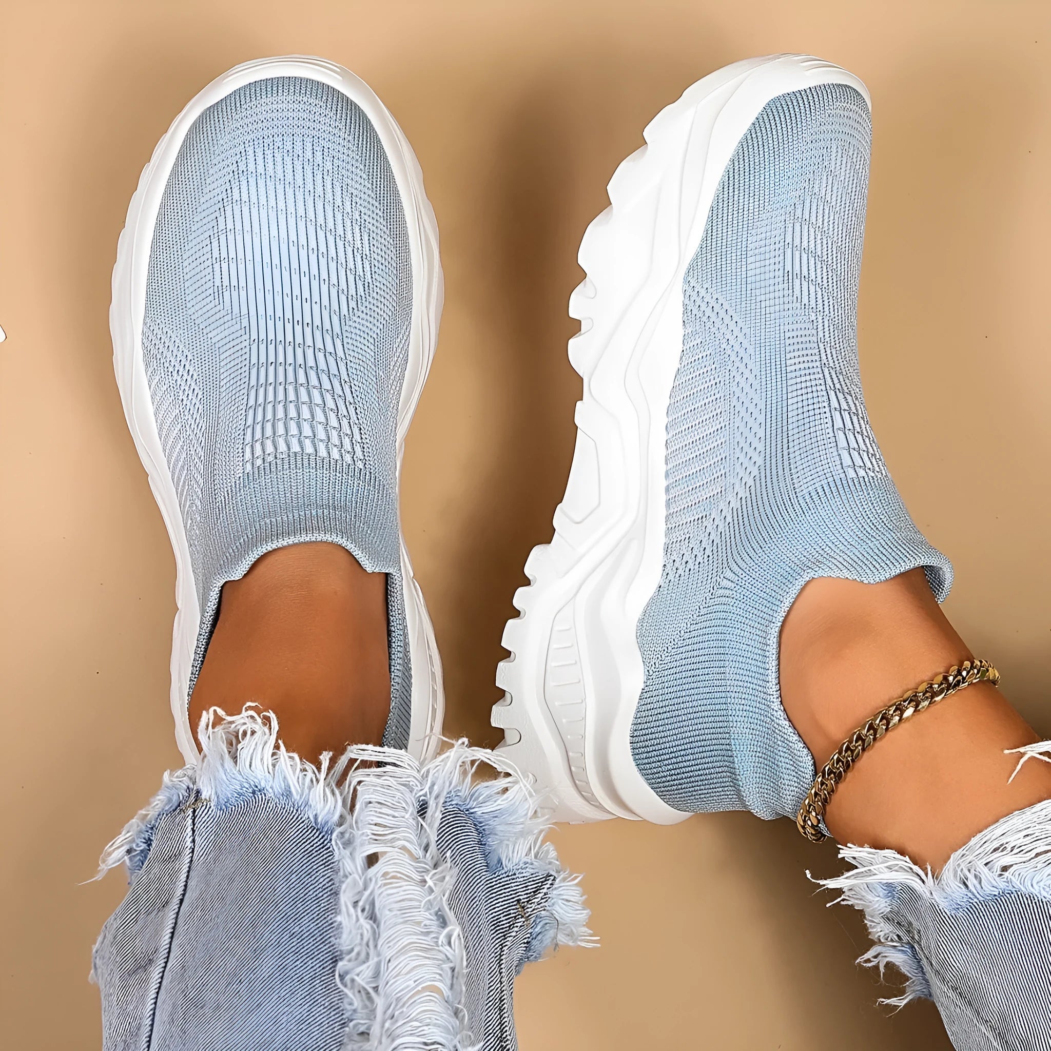 Women's light blue mesh slip-on sports shoes with a rounded toe and mid heel.