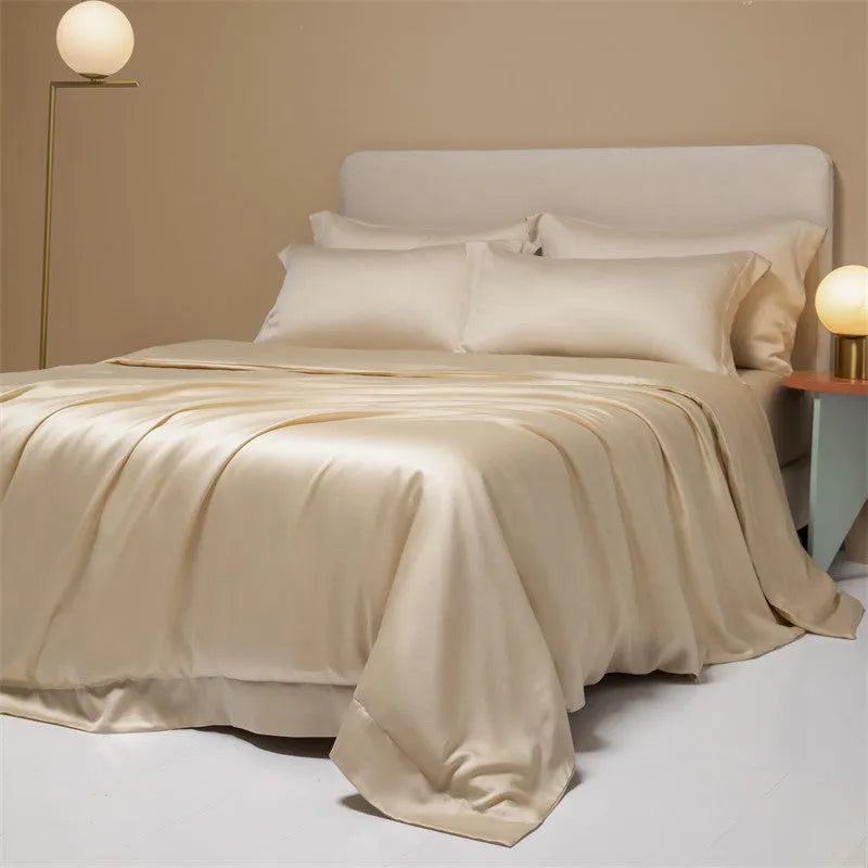 A neatly made bed with a Lenzing Tencel duvet cover and pillowcases in a soft grey colour.
