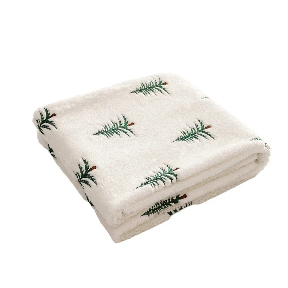 Christmas plush sofa blanket with embroidered tree design, white polyester, 127x152cm, on a sofa