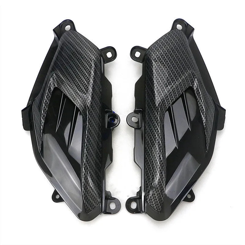Pair of YAMAHA NMAX carbon fibre-look LED side lamp replacements on a blue background.