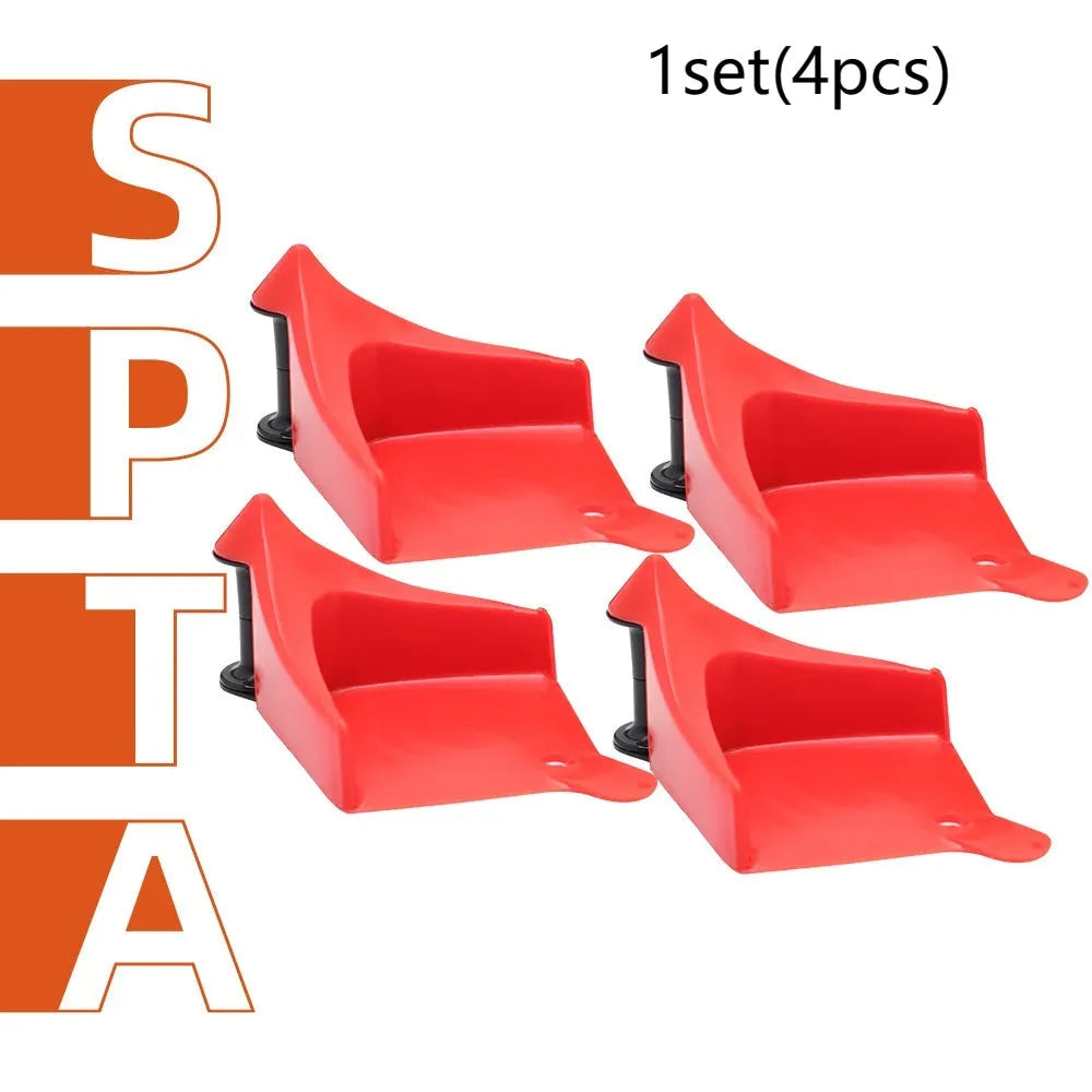 Set of four bright red, wedge-shaped rubber parking blocks for car tyres.