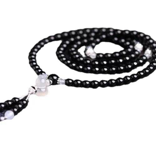 Black agate bracelet with 108 geometric natural stone beads on adjustable fastening