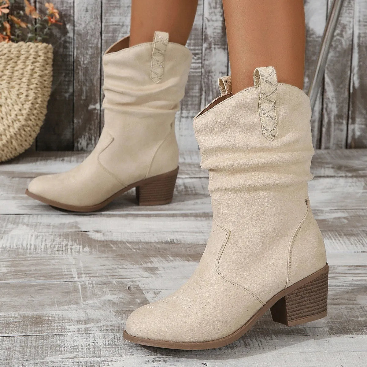 Women's mid-calf suede boots in lotus root colour with a 4cm stout heel and leather stitching detail on a wooden floor.