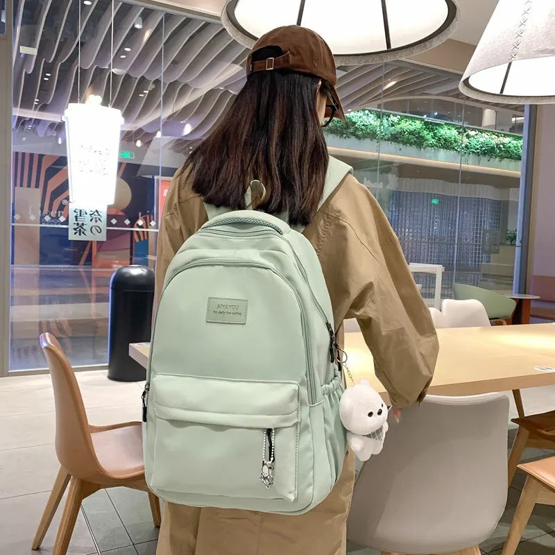 Large capacity nylon backpack for women, waterproof and wear-resistant, in solid colour with zips and straps