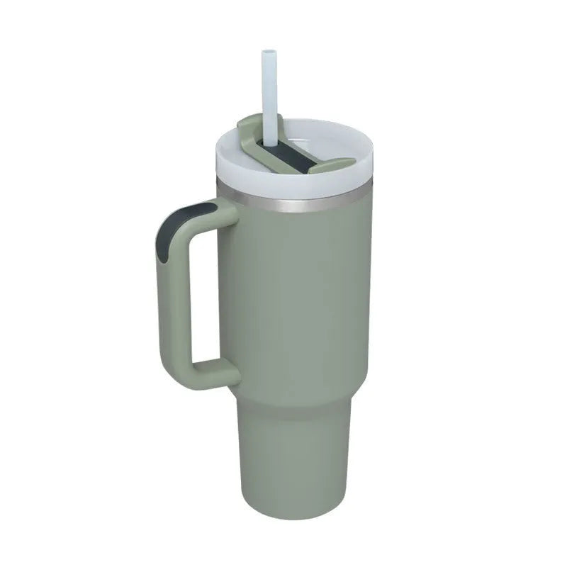 40 oz stainless steel insulated tumbler with a black handle, straw, and grey lid on a wooden table