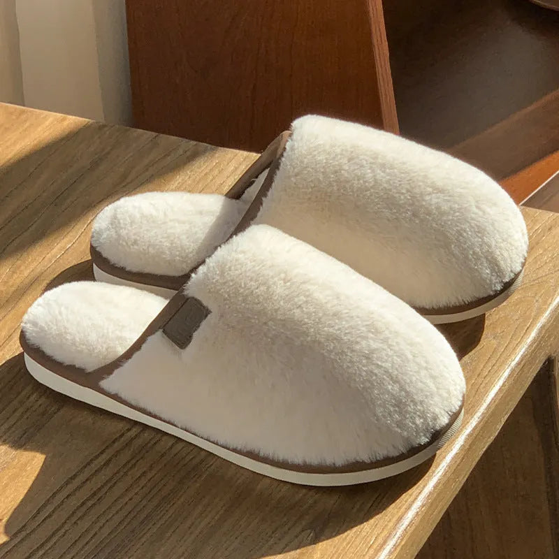 Solid colour plush slippers with PVC non-slip sole and car stitching detail on the upper.