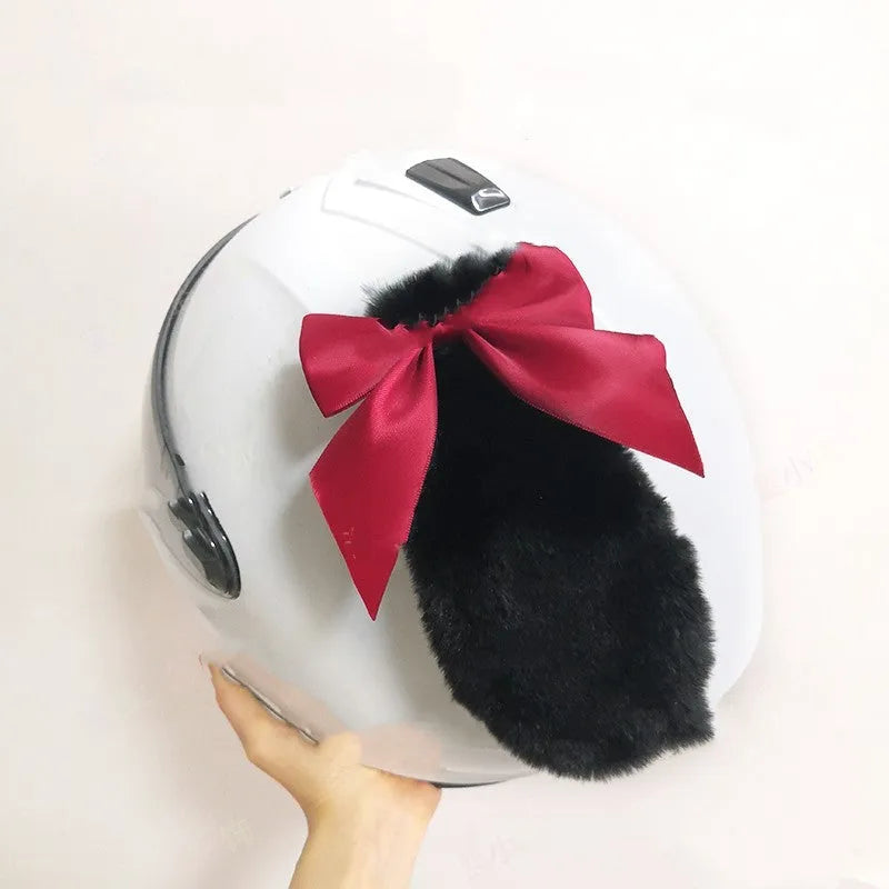 Black carbon fibre rabbit ears decoration attached to a motorcycle helmet