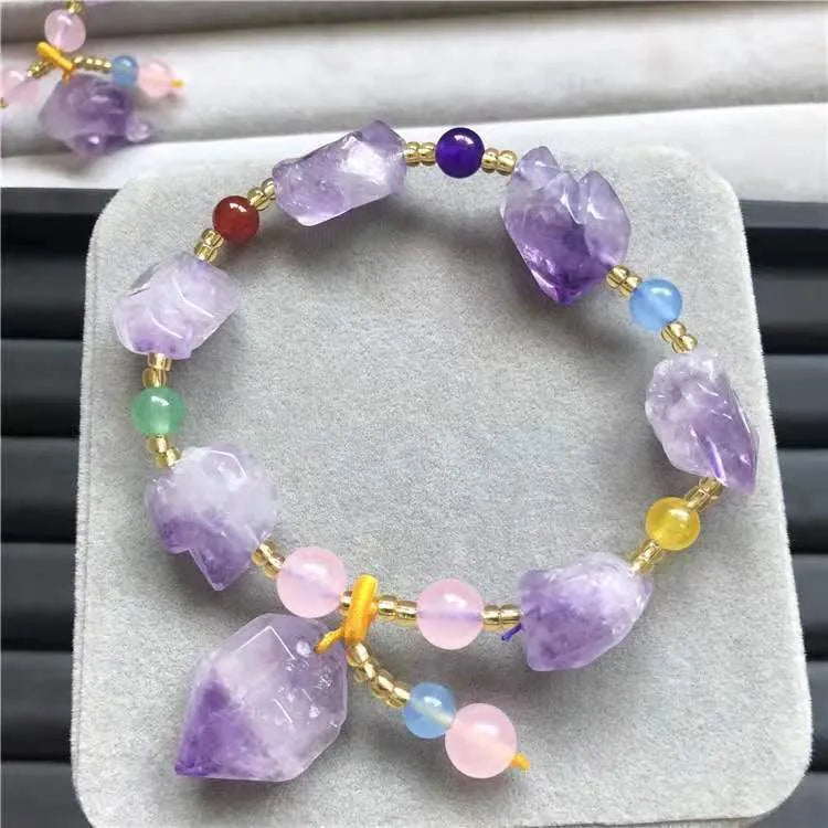Purple natural shaped amethyst bead bracelet for women with a silver fu character charm.