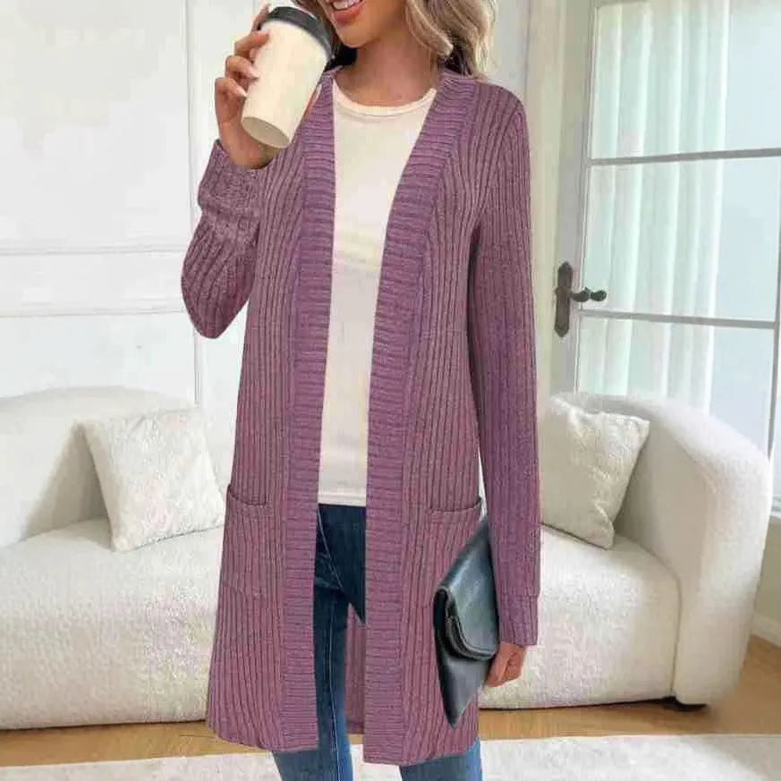 Long sleeve loose fit knitted cardigan jacket in black, shown on a hanger.