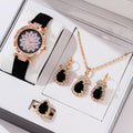 Women's quartz watch bracelet set with faux leather strap, round dial, and matching necklace ring earrings