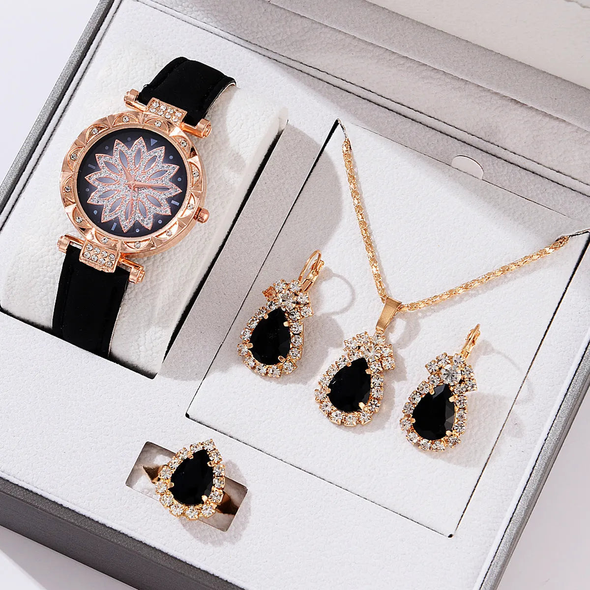 Women's quartz watch bracelet set with faux leather strap, round dial, and matching necklace ring earrings