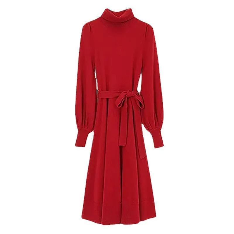 A rose red turtleneck knit dress with long sleeves, a loose hem, and an elastic waist on a hanger.