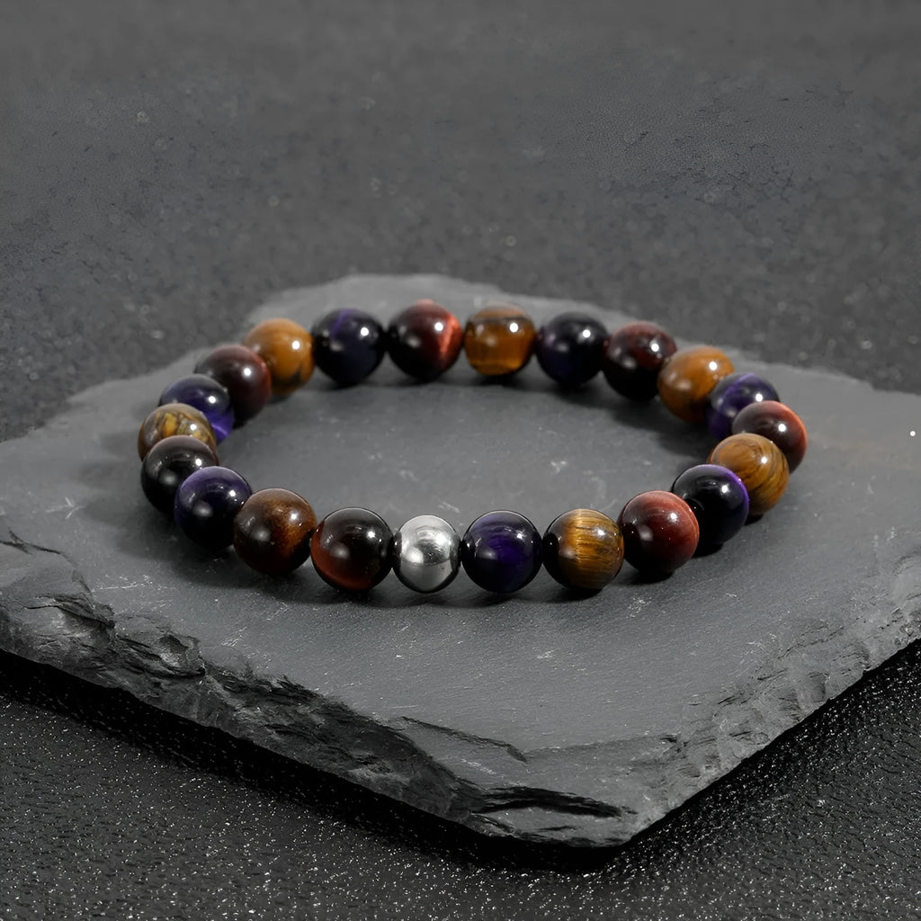 Handmade elastic tiger-eye stone bracelet showing yellow purple red colours in geometric pattern