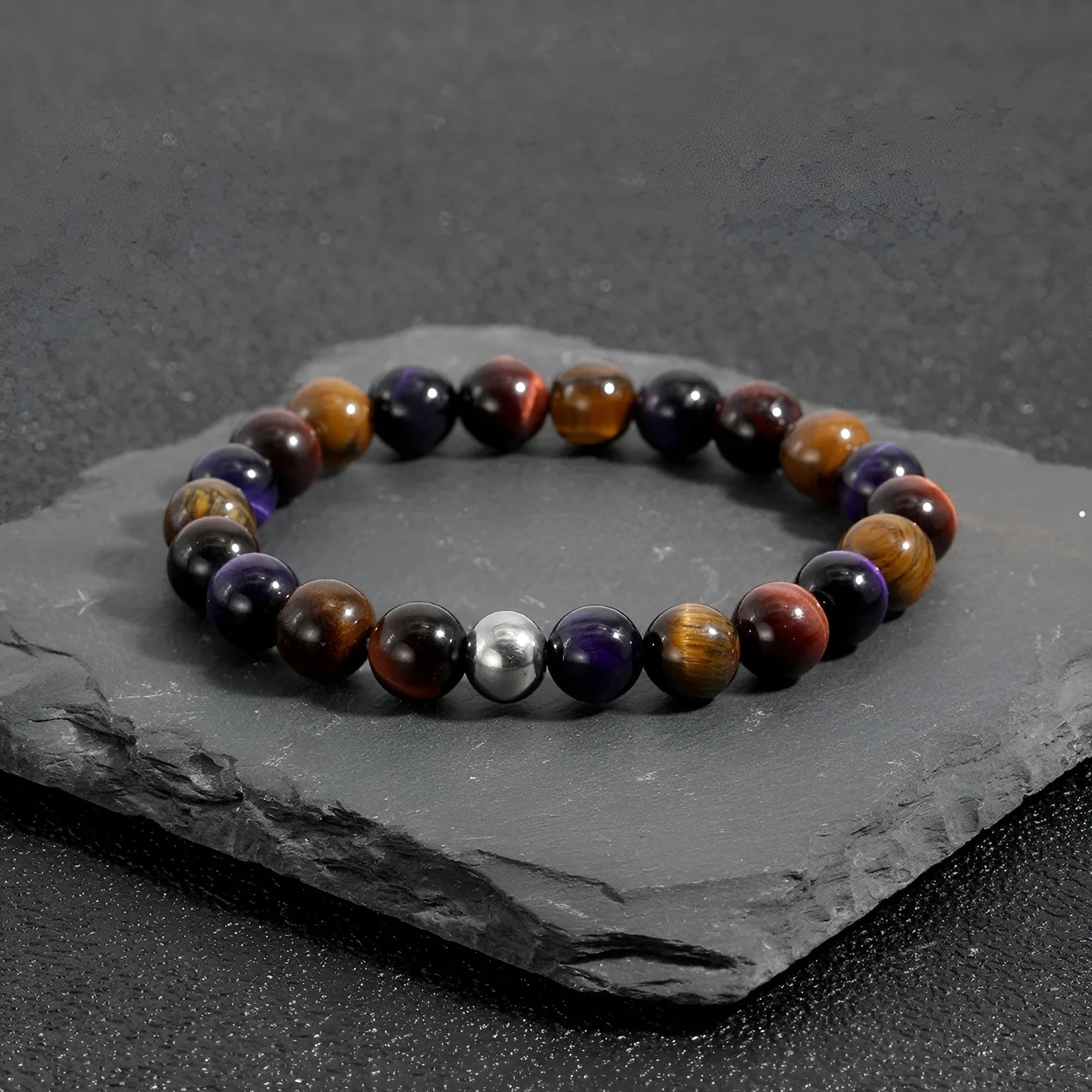 Handmade elastic tiger-eye stone bracelet showing yellow purple red colours in geometric pattern