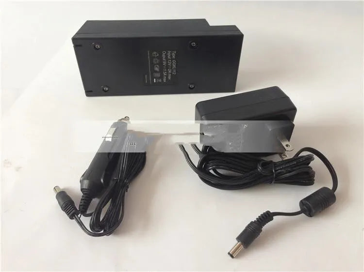GKL112 model compact white 220V car charger with US plug on a wooden workbench.