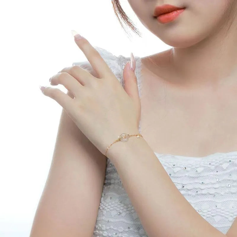 Silver women's bracelet with peace buckle charm, white chalcedony stone, and starry sky design with gold electroplating.