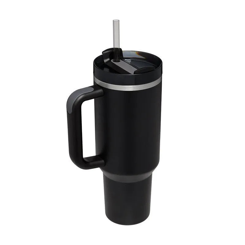 40 oz stainless steel insulated tumbler with a black handle, straw, and grey lid on a wooden table