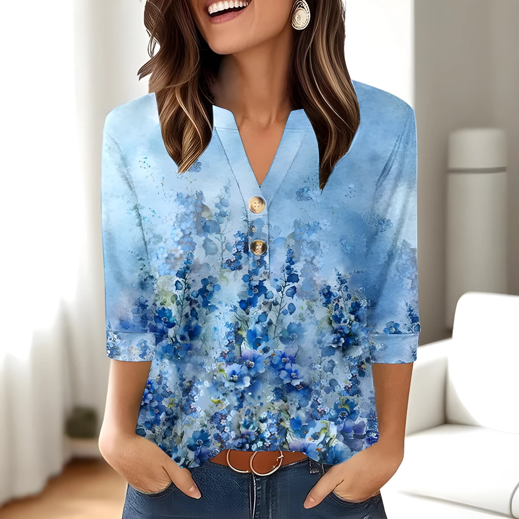 Women's loose-fit V-neck top with a blue 3D geometric pattern print, showcasing front view.
