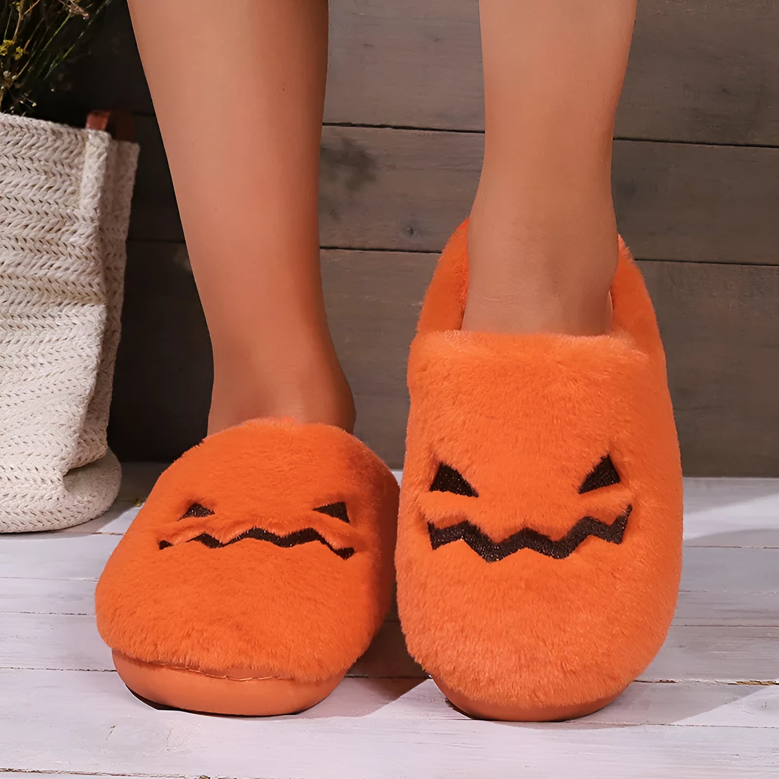 Orange coral velvet plush slippers with a non-slip PVC sole and fluffy lining.
