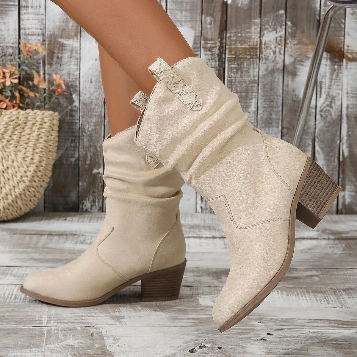Women's mid-calf suede boots in lotus root colour with a 4cm stout heel and leather stitching detail on a wooden floor.