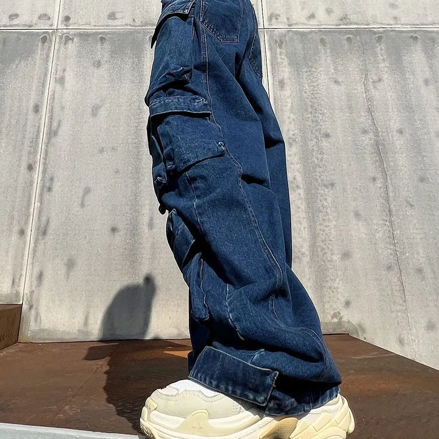 Dark blue distressed wide-leg jeans with a high waist and multiple pockets on a hanger
