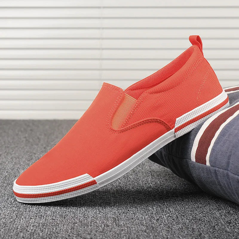 Men's low-top canvas sneakers in grey, black orange, or khaki with a vulcanised rubber sole.