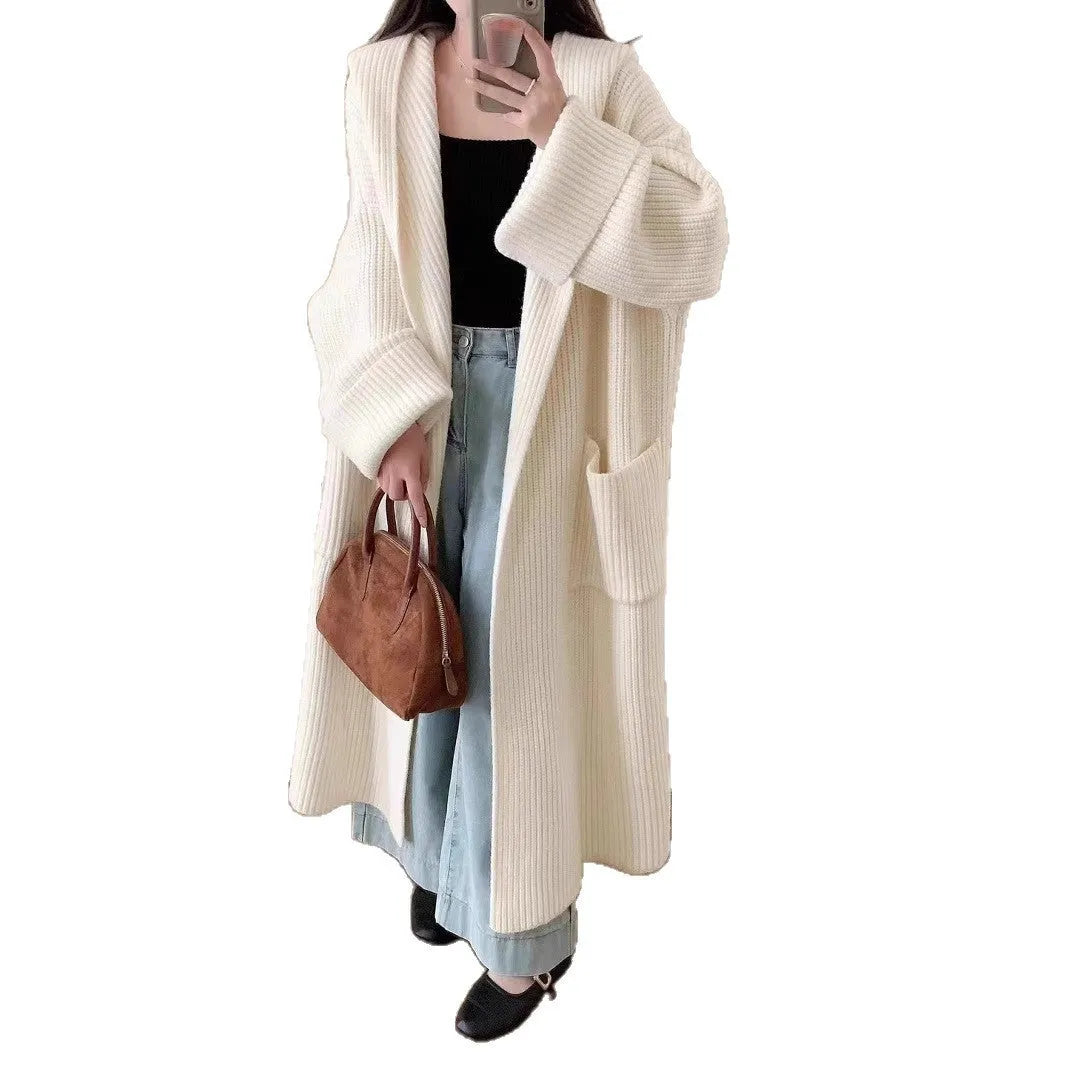 Loose-fitting beige hooded cardigan coat for women with raglan sleeves on a hanger.