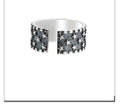 Adjustable multi five-pointed star ring in 925 silver on a plain background