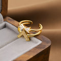 Gold geometric open fashion ring on a display stand, showing its adjustable shape.