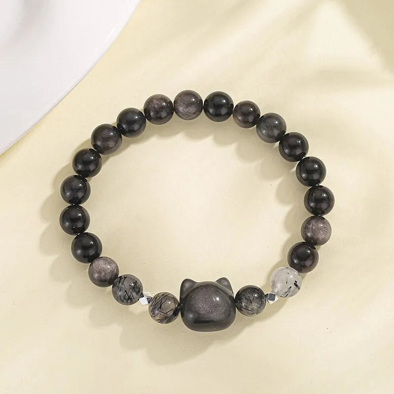 Women's obsidian crystal bracelet with silver cat charm and zodiac animal modelling on adjustable band