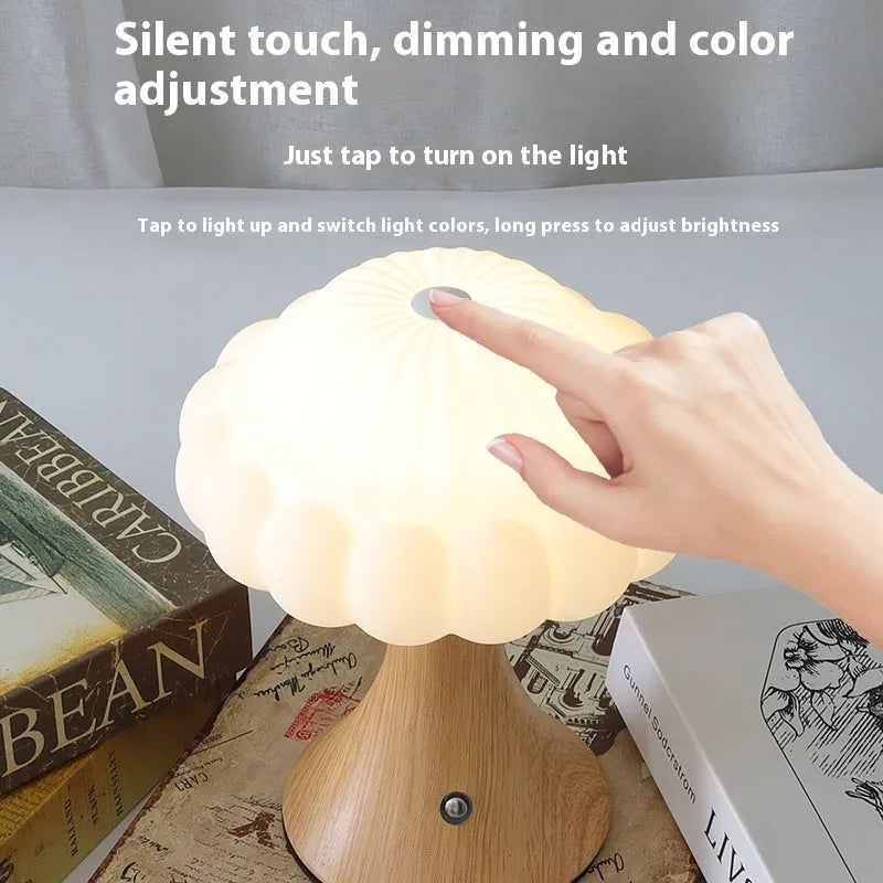 Small touch-controlled mushroom night lamp in wood grain colour on a table.