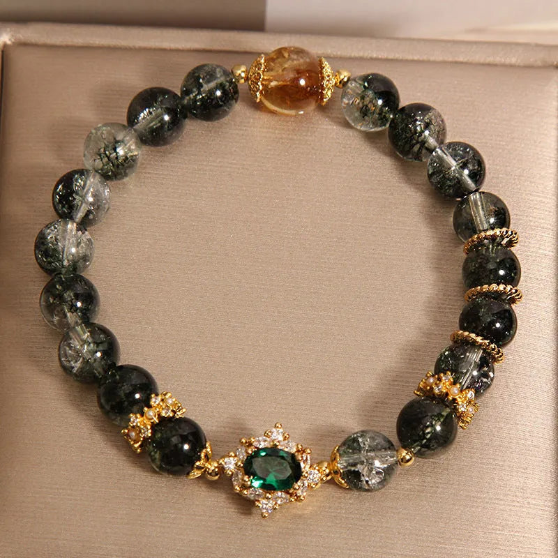 Women's green phantom quartz crystal bracelet with gold rutile needle inclusions and rhinestone accents