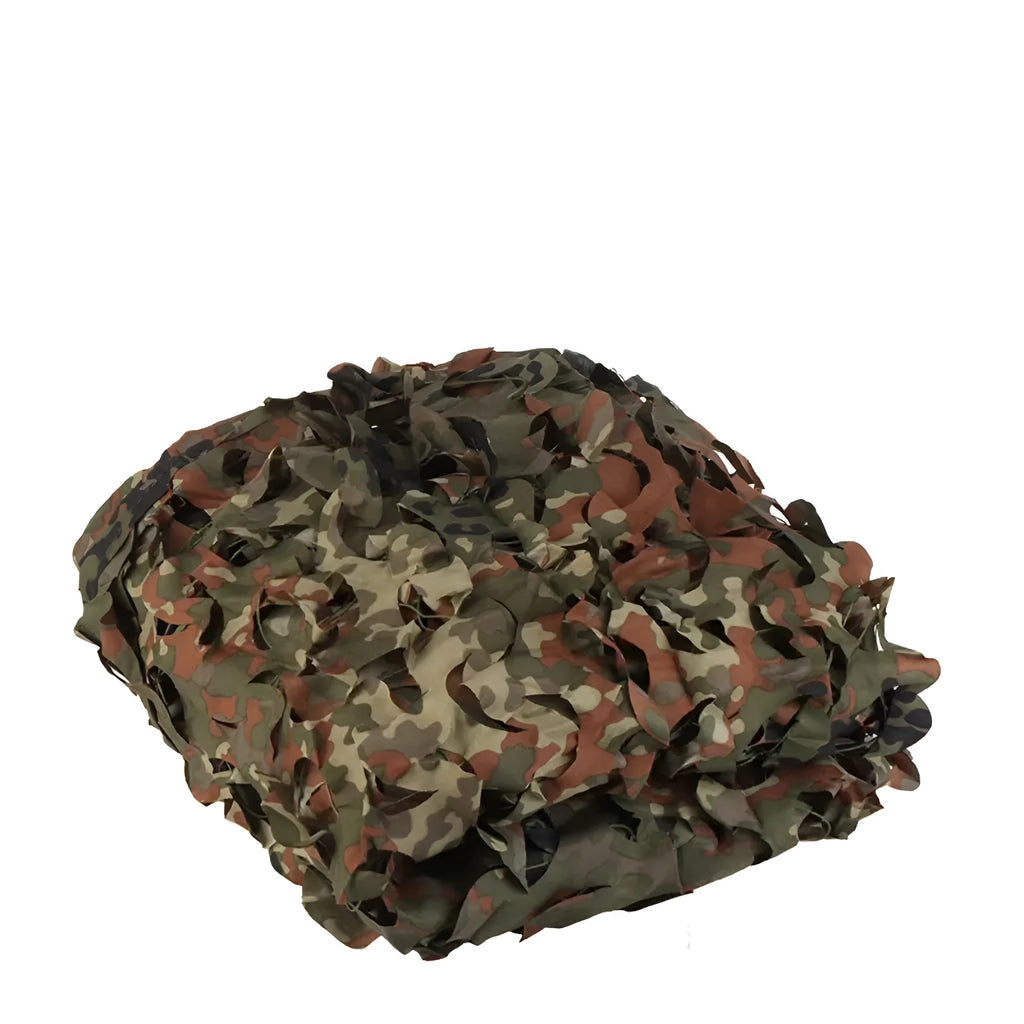 Green camouflage netting on a forest floor showing a multi-spot camouflage pattern.