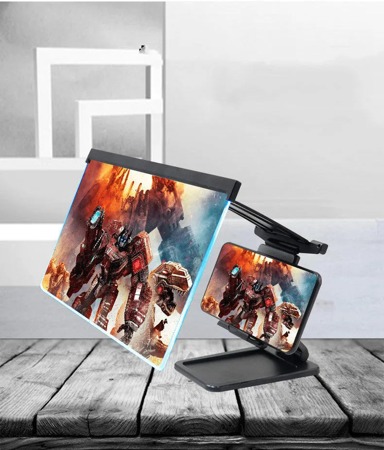 Black foldable mobile phone screen amplifier and detachable holder set up on a desk.
