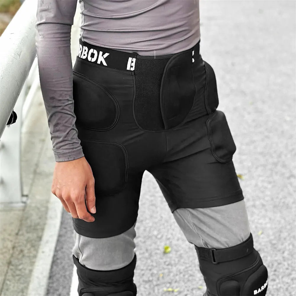 Black adult skating hip protection pad made of spandex and NBR foam on a grey background.