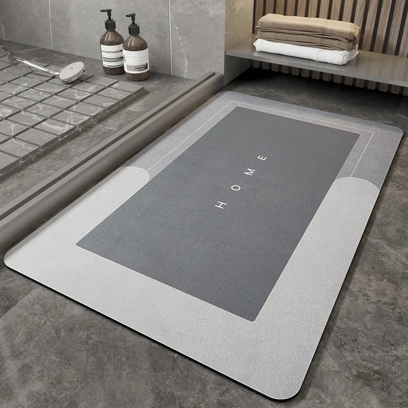 Machine woven bathroom floor mat in blue colour, shown in an oval shape on a tiled floor.