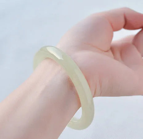 Ice-like silk jade round bar bracelet showing smooth stone surface and circular form