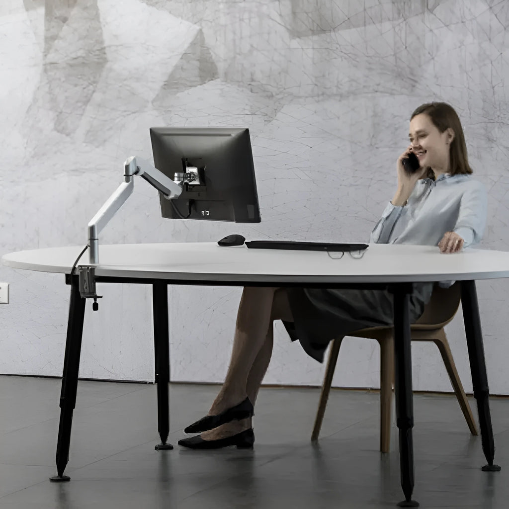 Silver aluminium free-standing laptop stand with extended telescopic arm holding a notebook.