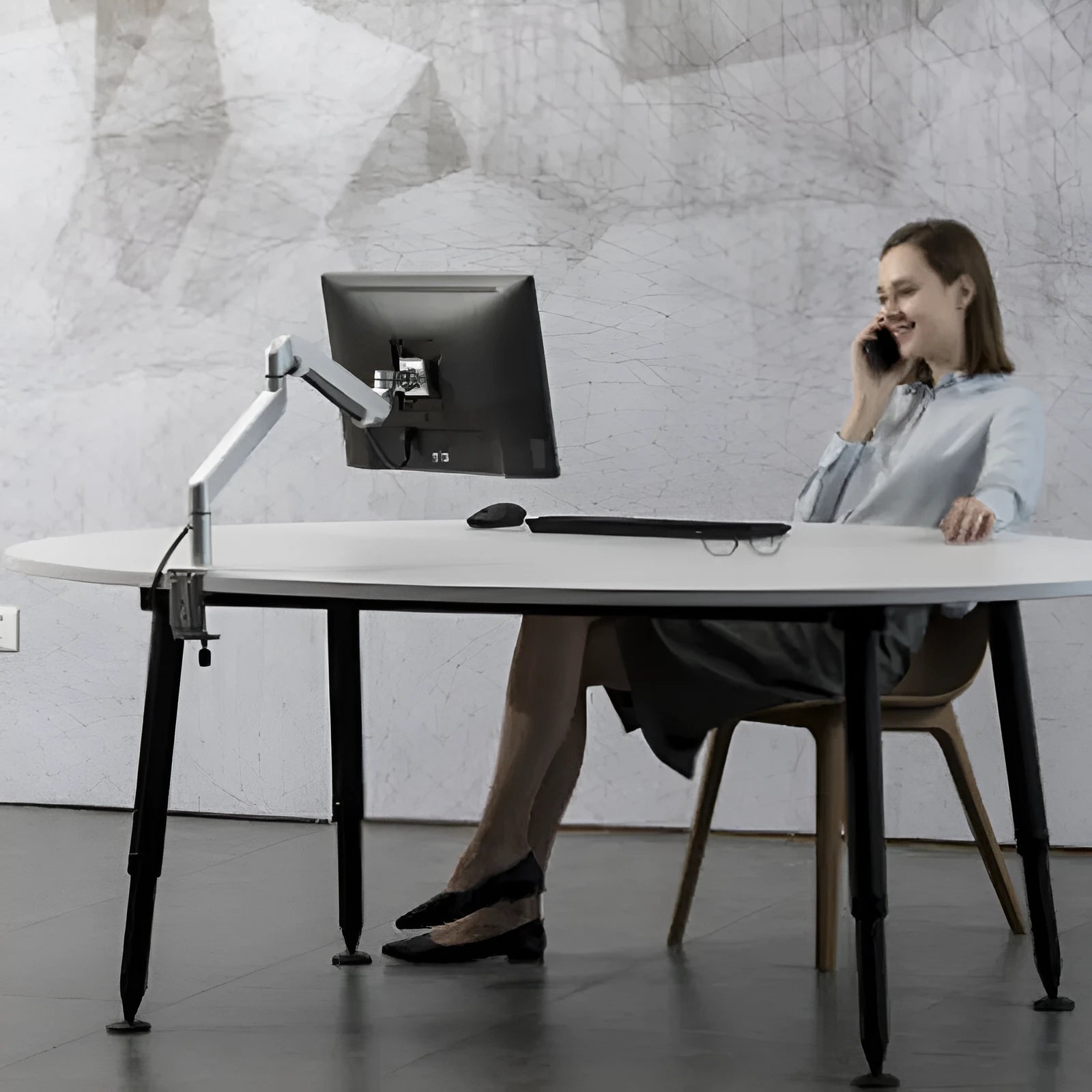 Silver aluminium free-standing laptop stand with extended telescopic arm holding a notebook.