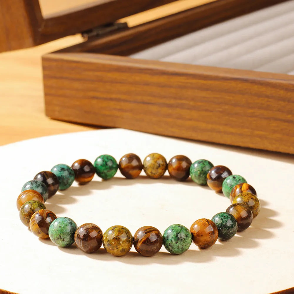 Tiger eye stone bracelet showing antique flower design with natural stone beads