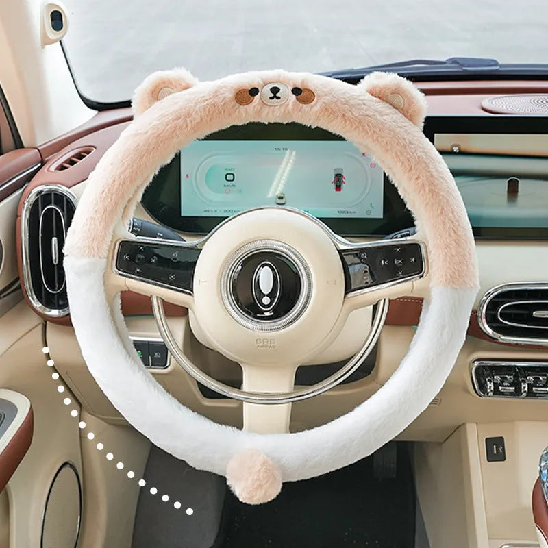 Plush winter steering wheel cover with embroidered bear design, shown on a car steering wheel.