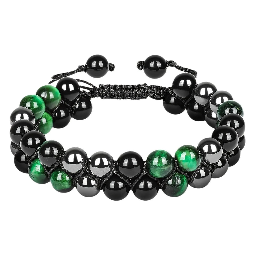 Close-up of a unisex alloy bracelet featuring green cat's eye tiger eye stones and red iron stone with an auspicious elephant charm.