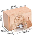 Wooden and transparent glass bottle-shaped USB flash drive on a wooden surface.